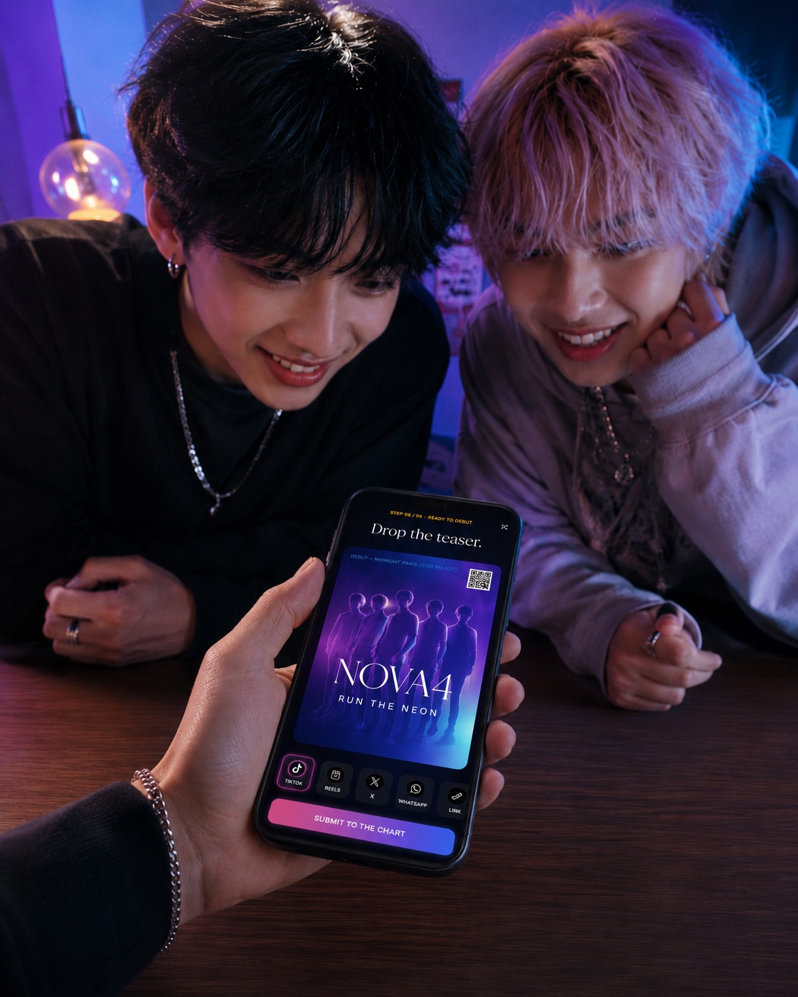 Friends watching a Debut Code teaser submission screen on a phone
